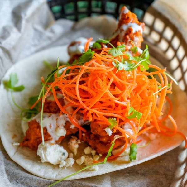 Crush Taco's buffalo chicken taco with shredded carrots, cilantro, and blue cheese crumbles.